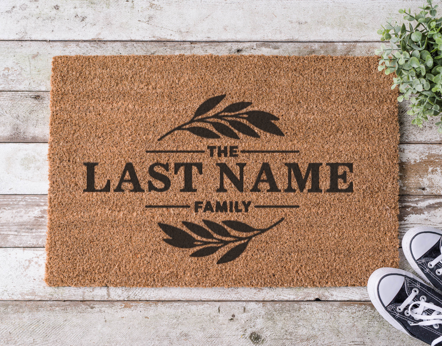 Coir doormat with a custom family last name, hand-painted in bold lettering