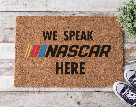 Coir doormat with the phrase ‘We Speak Racing Here,’ hand-painted in bold, motorsport-inspired lettering