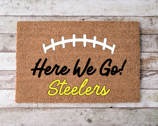 Pittsburgh Steelers themed doormat with ‘Here We Go’ text in black and gold