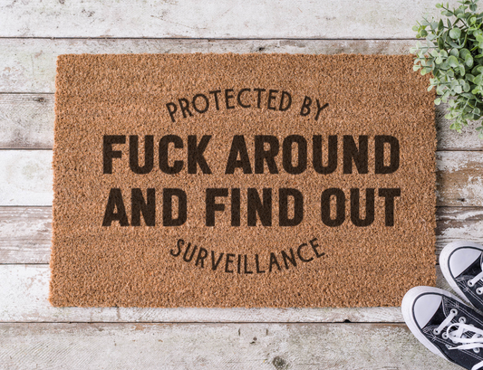Coir doormat with the phrase ‘Fuck Around and Find Out,’ hand-painted in bold black lettering with a tough, no-nonsense vibe