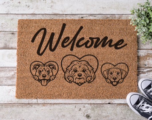Coir doormat with the word ‘Welcome’ above illustrations of three dogs, hand-painted in a pet-inspired, customizable design