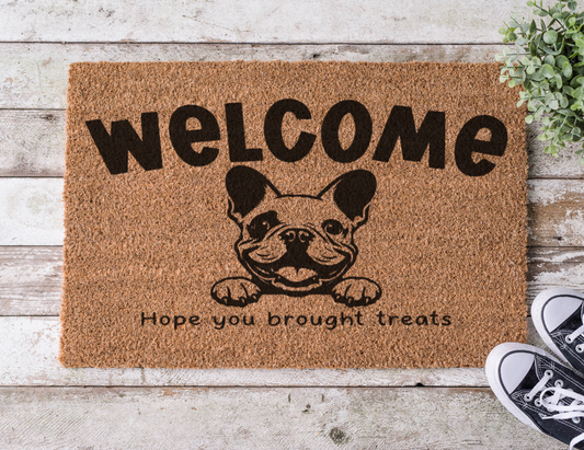 Coir doormat with the phrase ‘Hope You Brought Treats,’ hand-painted in bold lettering with a French Bulldog design