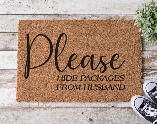 Coir doormat with the phrase ‘Please Hide Packages from Husband,’ hand-painted in playful black lettering with a humorous tone