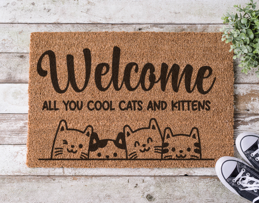 Coir doormat with the phrase Welcome All You Cool Cats and Kittens,’ hand-painted in stylish lettering with a fun, feline-inspired vibe