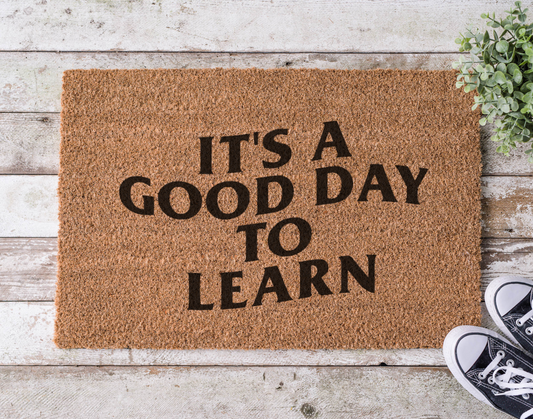 Coir doormat with the phrase ‘It’s a Good Day to Learn,’ hand-painted in cheerful, classroom-inspired lettering