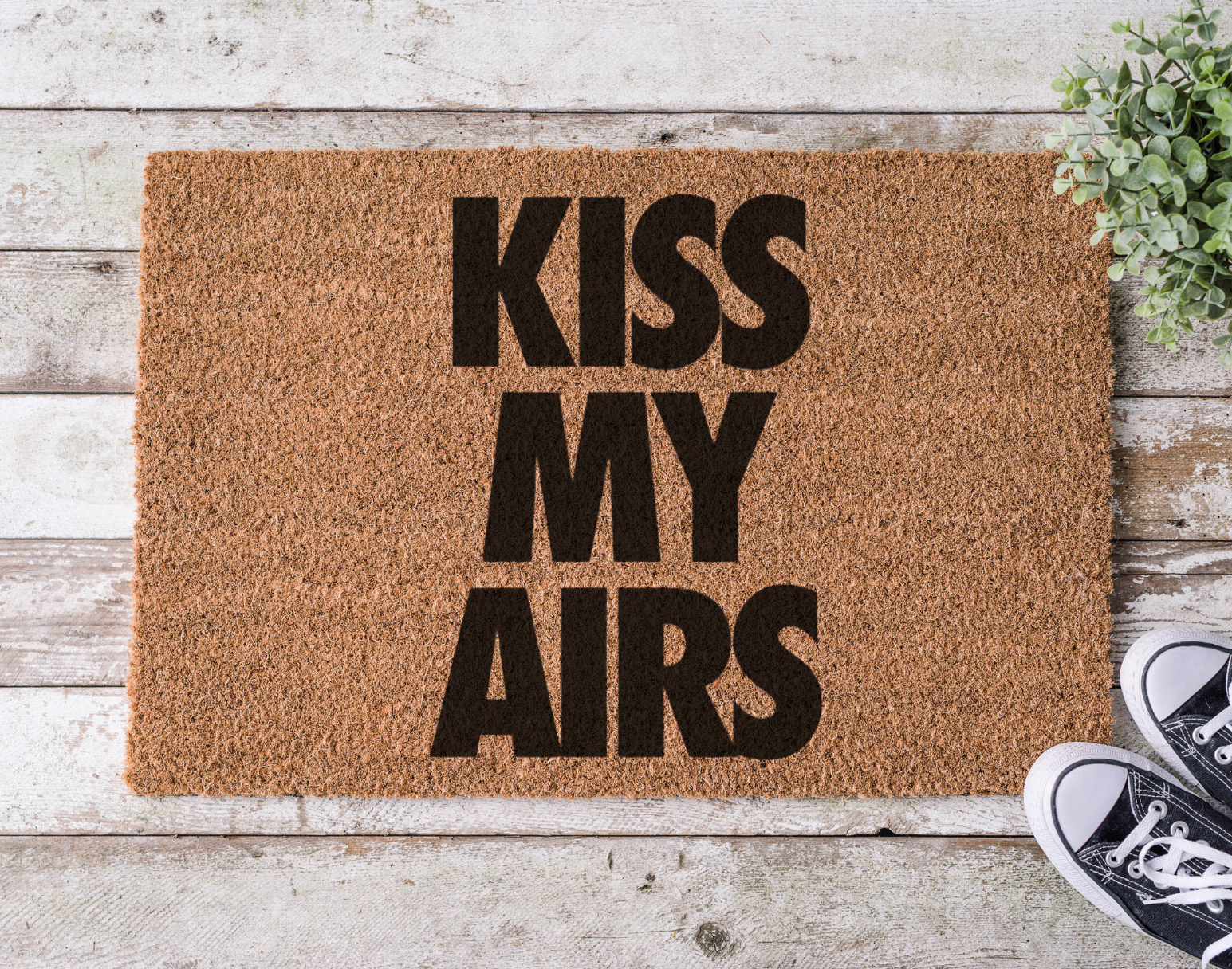 Coir doormat with the phrase ‘Kiss My Airs,’ hand-painted in bold, streetwear-inspired lettering with a nod to sneaker culture