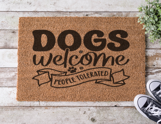 Coir doormat with the phrase ‘Dogs Welcome, People Tolerated,’ hand-painted in bold lettering with a playful, pet-friendly vibe