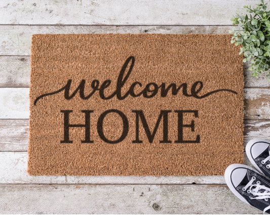 Coir doormat with the phrase ‘Welcome Home,’ hand-painted in elegant black script for a cozy, inviting entryway