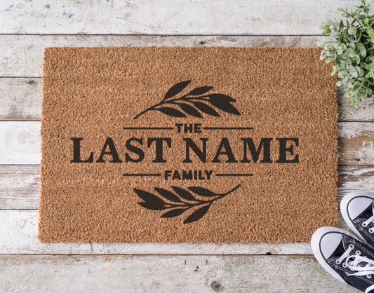 Coir doormat with a custom family last name, hand-painted in bold lettering

