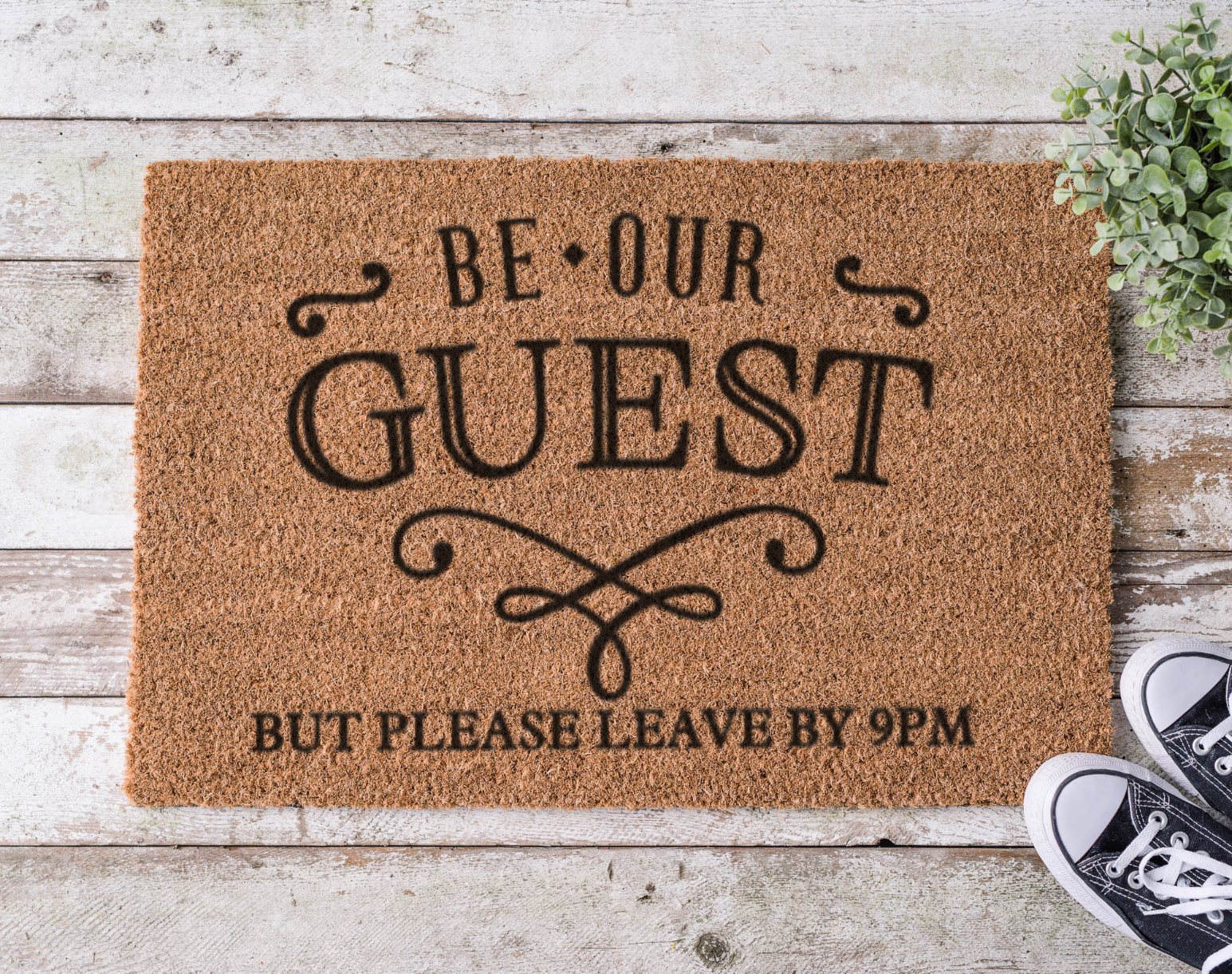 Coir doormat with the phrase ‘Be Our Guest but Leave by 9,’ hand-painted in bold, playful lettering for introverts and early sleepers