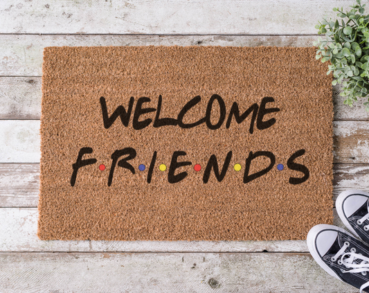 Coir doormat with the phrase ‘Welcome Friends,’ hand-painted in a style inspired by the Friends TV show title font and colors