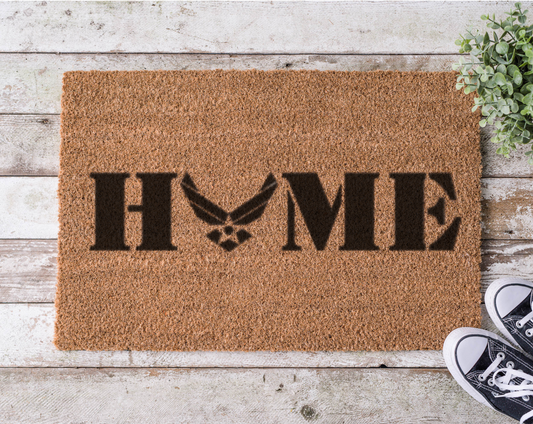 Coir doormat with the word ‘Home’ featuring the U.S. Air Force logo as the letter O, hand-painted in bold black 