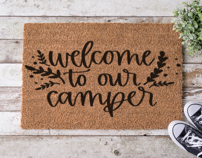 Coir doormat with the phrase ‘Welcome to Our Camper,’ hand-painted with a cozy camping theme