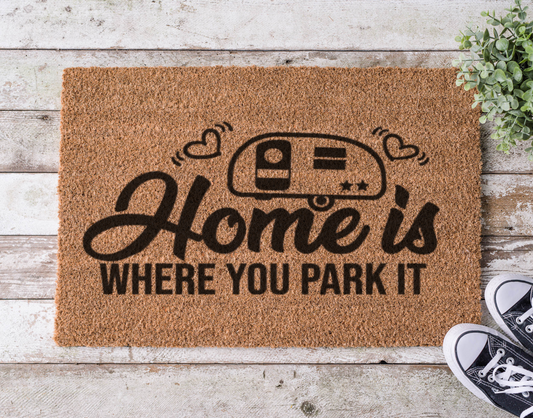 Camping-themed coir doormat that says ‘Home is Where You Park It,’ hand-painted with an RV design

