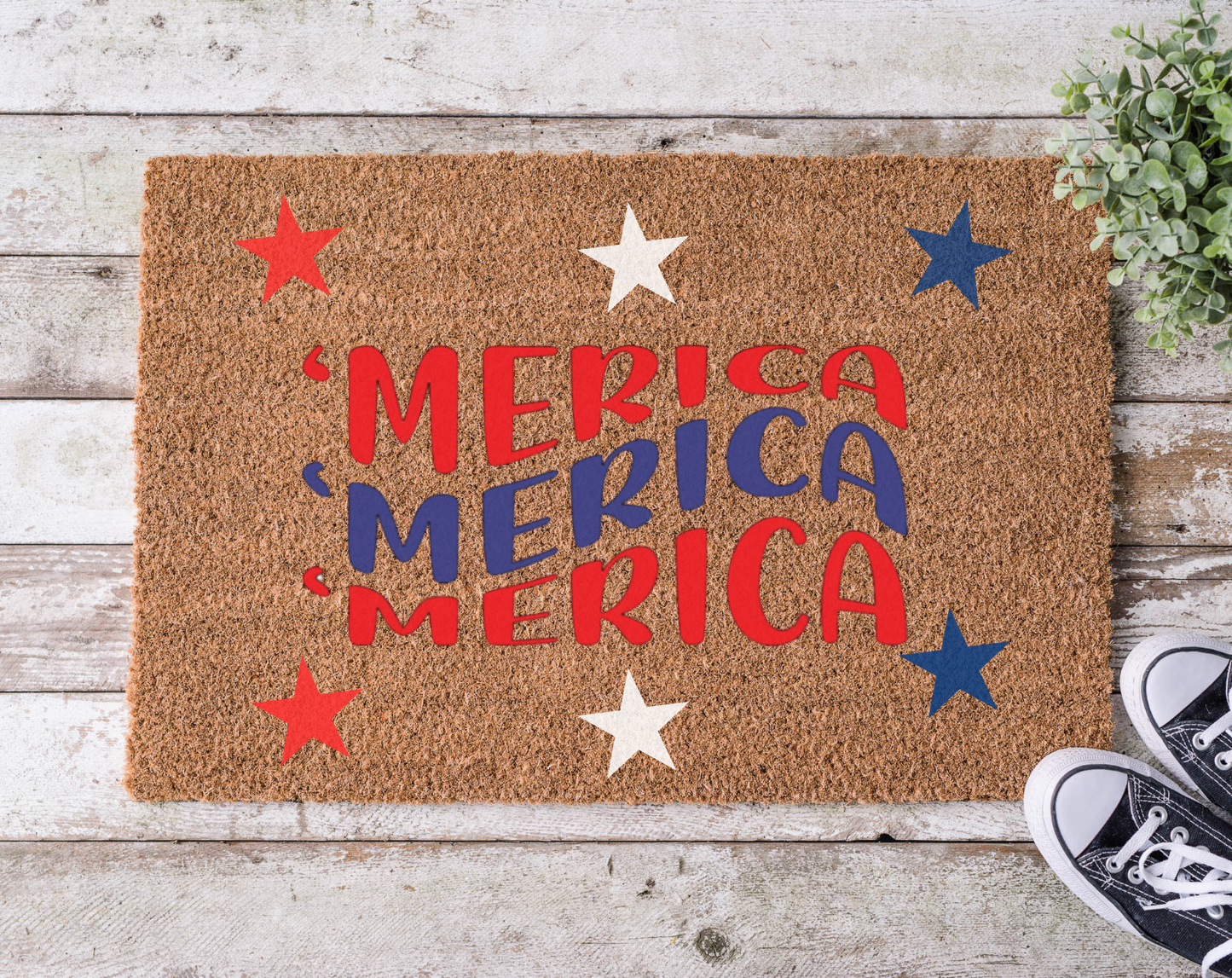 A rectangular doormat with a brown background and the word 'MERICA' written in bold, red and blue letters, surrounded by decorative stars in red and blue colors.