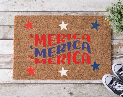 A rectangular doormat with a brown background and the word 'MERICA' written in bold, red and blue letters, surrounded by decorative stars in red and blue colors.