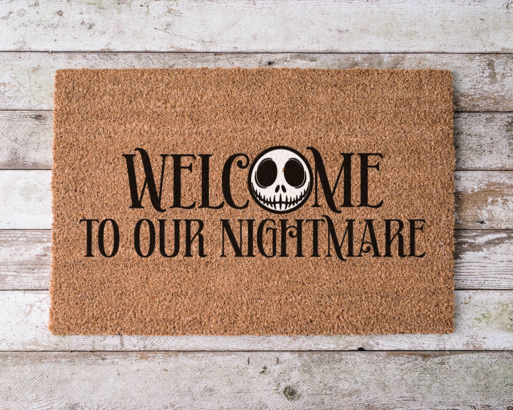 Hand-painted coir doormat with Jack Skellington and text ‘Welcome to Our Nightmare’ – Halloween porch décor.