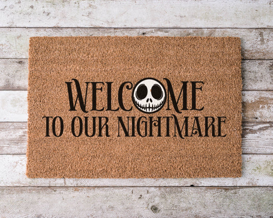 Hand-painted coir doormat with Jack Skellington and text ‘Welcome to Our Nightmare’ – Halloween porch décor.