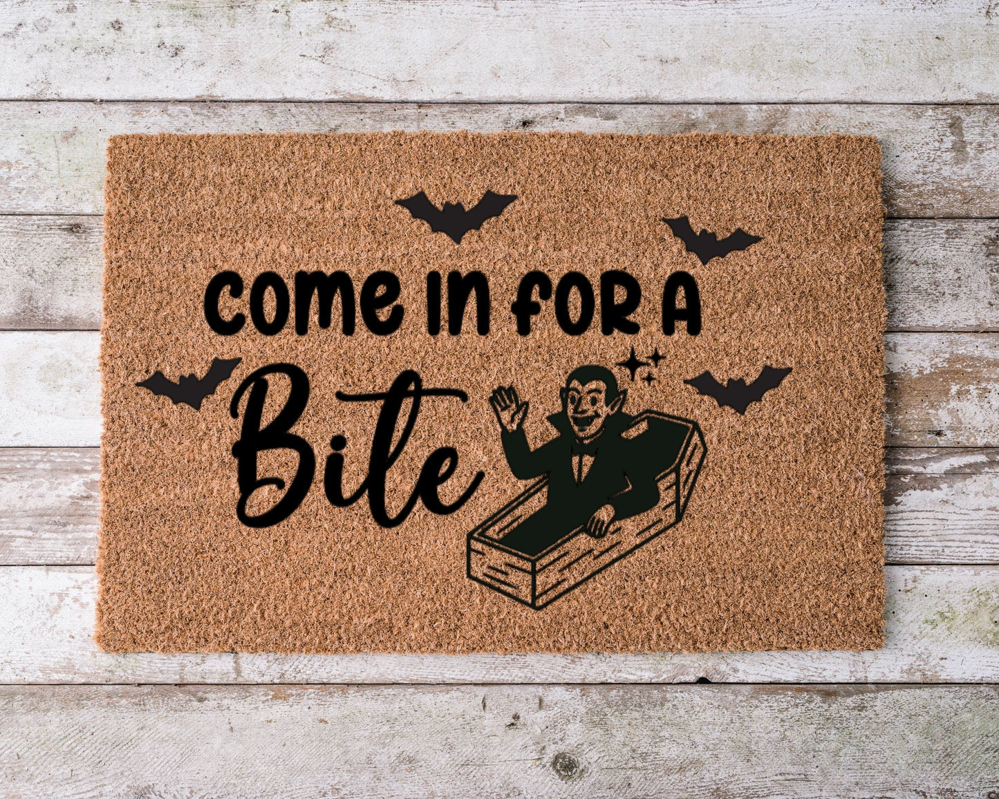 Halloween doormat that says “Come in for a bite” with a smiling cartoon vampire illustration – spooky fall porch decor.
