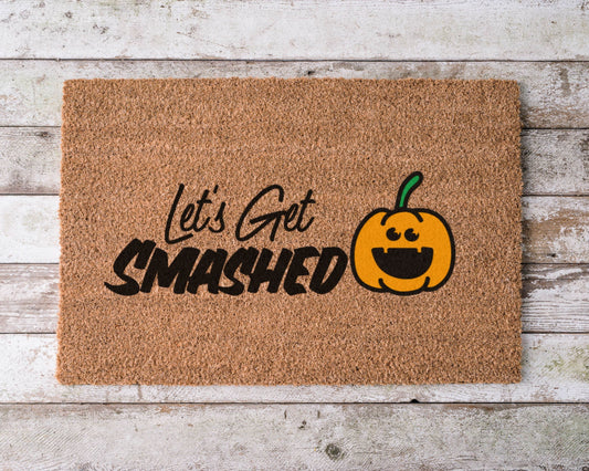 Doormat that says “Let’s Get Smashed” with hand-painted pumpkin – funny fall-themed welcome mat for Halloween or autumn porch decor.