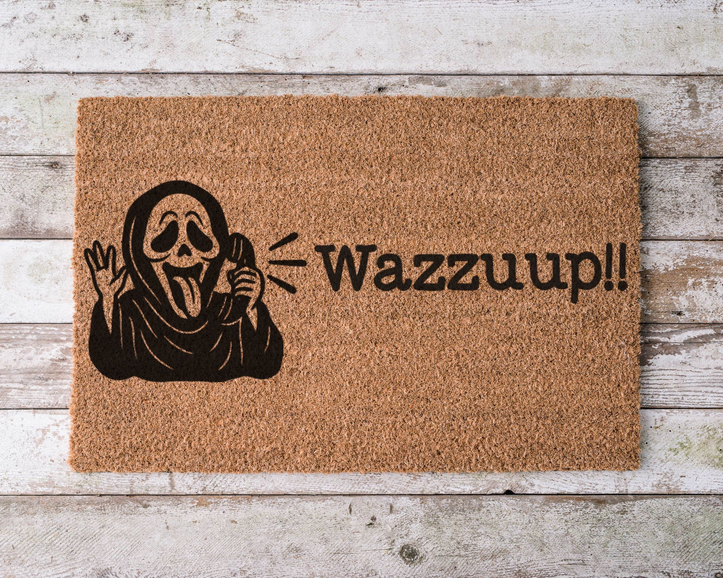 Halloween doormat with the phrase “Wazzzup” and a hand-painted image of Ghostface from Scream – horror movie-themed spooky porch decor.